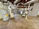 Unfinished basement with exposed ductwork, water heater and concrete floor at 2724 Peachtree Rd, Statesville, NC 28625