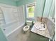 Bathroom featuring tub, toilet, marble-look floor and vanity with tiled backsplash at 2724 Peachtree Rd, Statesville, NC 28625