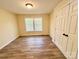 Bright bedroom features a window, wood-look flooring, and a closet at 2724 Peachtree Rd, Statesville, NC 28625