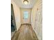 Hallway with white doors, wood-look floors, and a back door at 2724 Peachtree Rd, Statesville, NC 28625