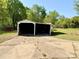 Two-car detached garage with a concrete driveway, ready for your vehicles and outdoor equipment at 2724 Peachtree Rd, Statesville, NC 28625