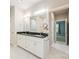 Modern bathroom featuring double vanity sinks, granite countertops, and tiled floors at 3004 Village Ridge Dr, Gastonia, NC 28056