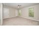 Comfortable bedroom with neutral carpet, a ceiling fan, and windows with views of a green treeline at 3004 Village Ridge Dr, Gastonia, NC 28056