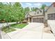 View of the home from across the street, showcasing the well-kept lawn and lush greenery surrounding the property at 3004 Village Ridge Dr, Gastonia, NC 28056
