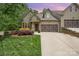 Charming home featuring stone accents, a two-car garage, a well-manicured lawn and beautiful landscaping at 3004 Village Ridge Dr, Gastonia, NC 28056
