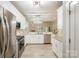 Bright, spacious kitchen with white cabinets, stainless steel appliances, granite countertops, and an open layout at 3004 Village Ridge Dr, Gastonia, NC 28056