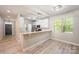 Open concept kitchen and dining area featuring white cabinets, a breakfast bar, and stainless steel appliances at 3004 Village Ridge Dr, Gastonia, NC 28056