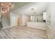Open-concept living room with stairs, modern lighting, and an eat-in kitchen bar area at 3004 Village Ridge Dr, Gastonia, NC 28056