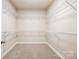 Spacious walk-in closet with multiple levels of shelving, perfect for organizing clothes and accessories at 3004 Village Ridge Dr, Gastonia, NC 28056