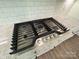 Close-up of a stainless steel Frigidaire Gallery cooktop and granite countertops with white subway tile backsplash at 3022 Cedar Falls Dr # 16, Waxhaw, NC 28173