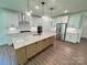 Modern open kitchen with stainless appliances, a large island, and white cabinetry at 3022 Cedar Falls Dr # 16, Waxhaw, NC 28173