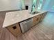Granite kitchen island with a stainless steel sink, modern faucet, dishwasher, and light wood cabinets at 3022 Cedar Falls Dr # 16, Waxhaw, NC 28173