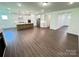 Open floorplan featuring dark vinyl wood floors, white walls, and a modern kitchen at 3022 Cedar Falls Dr # 16, Waxhaw, NC 28173