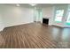 Bright living room featuring a gas fireplace, hardwood-style flooring, and access to outdoor views at 3022 Cedar Falls Dr # 16, Waxhaw, NC 28173