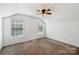 An empty bedroom with two windows and a ceiling fan at 3219 Cottage Rose Ln, Rock Hill, SC 29732