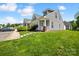 Inviting home exterior showcasing light siding, neat landscaping, and a well-maintained lawn under a blue sky at 3219 Cottage Rose Ln, Rock Hill, SC 29732