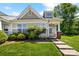Charming single-story home with a well-maintained lawn and inviting entrance with brick pillar and concrete steps at 3219 Cottage Rose Ln, Rock Hill, SC 29732
