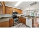 Open concept kitchen with wooden cabinets, stainless steel appliances, and a view into the living room at 3219 Cottage Rose Ln, Rock Hill, SC 29732