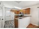 Kitchen with wooden cabinets, stainless steel appliances, and a gray countertop, door leading to backyard at 3219 Cottage Rose Ln, Rock Hill, SC 29732