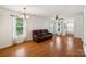 Bright and airy living room with hardwood floors, large windows, white walls, and a leather sofa at 3219 Cottage Rose Ln, Rock Hill, SC 29732