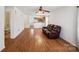 Spacious living room with hardwood floors, open layout, ceiling fan, and direct access to the kitchen at 3219 Cottage Rose Ln, Rock Hill, SC 29732