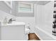 Bright bathroom featuring a tub-shower combo, fresh white fixtures, and modern sink at 3300 Bonaire Dr, Charlotte, NC 28208