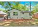 A lovely white brick home with dark trim, landscaped with mulch, and a lush lawn creating a welcoming curb appeal at 3300 Bonaire Dr, Charlotte, NC 28208
