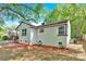 Charming white brick home featuring classic architecture, complemented by a well-maintained lawn and mature trees at 3300 Bonaire Dr, Charlotte, NC 28208
