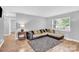 Cozy living room featuring a comfortable sofa, soft rug, and plenty of natural light at 3300 Bonaire Dr, Charlotte, NC 28208
