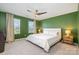 Bedroom with a ceiling fan, two windows, carpeted floors, and a neutral-colored bed at 334 Bluebonnet Dr, Salisbury, NC 28146