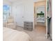 Bright bedroom with a comfortable chair and view into an adjacent room at 334 Bluebonnet Dr, Salisbury, NC 28146
