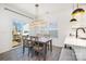 Bright dining area features modern lighting, gray wood flooring, and access to the outdoor deck at 334 Bluebonnet Dr, Salisbury, NC 28146