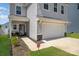 This two-story house has a two-car garage and attractive stone accents at 334 Bluebonnet Dr, Salisbury, NC 28146