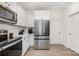 Bright kitchen with stainless steel refrigerator, white cabinetry, and neutral flooring at 334 Bluebonnet Dr, Salisbury, NC 28146