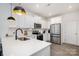 Modern kitchen with stainless steel appliances, white cabinetry, and quartz countertops at 334 Bluebonnet Dr, Salisbury, NC 28146