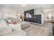 Open-concept living room with a large sofa and a view into the kitchen at 334 Bluebonnet Dr, Salisbury, NC 28146