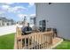 The backyard's wooden deck with a grill, lounge chairs, and a sliding door to the home at 334 Bluebonnet Dr, Salisbury, NC 28146