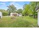 Expansive backyard featuring a brick house, green lawn, deck, and mature trees at 3378 Tanglewood Dr, Rock Hill, SC 29732