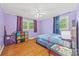 Bedroom with blue bed, hardwood floors, and window with natural light at 3378 Tanglewood Dr, Rock Hill, SC 29732