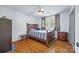 Cozy bedroom features hardwood floors, a wooden bed frame, and plenty of natural light at 3378 Tanglewood Dr, Rock Hill, SC 29732