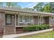 Charming brick home with a covered front porch and rocking chairs at 3378 Tanglewood Dr, Rock Hill, SC 29732
