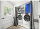 Bright laundry room featuring modern appliances, storage cabinets, and natural light from the nearby door at 3378 Tanglewood Dr, Rock Hill, SC 29732