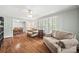 Bright living room featuring hardwood floors, neutral paint, and large windows with plantation shutters at 3378 Tanglewood Dr, Rock Hill, SC 29732