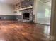 Open living room with hardwood floors and a brick fireplace at 3378 Tanglewood Dr, Rock Hill, SC 29732