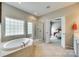 Bathroom featuring a soaking tub, separate shower, and open access to the bedroom at 349 Miners Cove Way, Fort Mill, SC 29708
