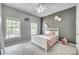 Cozy bedroom featuring soft gray walls, stylish decor, and two windows that provide natural lighting at 349 Miners Cove Way, Fort Mill, SC 29708