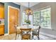 Cozy breakfast nook with a round table, natural light, and custom wood door detail at 349 Miners Cove Way, Fort Mill, SC 29708