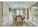 Elegant dining room with wainscoting, a stylish chandelier, and a round table perfect for gatherings at 349 Miners Cove Way, Fort Mill, SC 29708