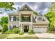 Charming two-story home features a welcoming front porch, attached two-car garage, and well-manicured landscaping at 349 Miners Cove Way, Fort Mill, SC 29708