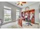 Bright home office with ample natural light, built-in bookshelves, and a spacious desk area at 349 Miners Cove Way, Fort Mill, SC 29708